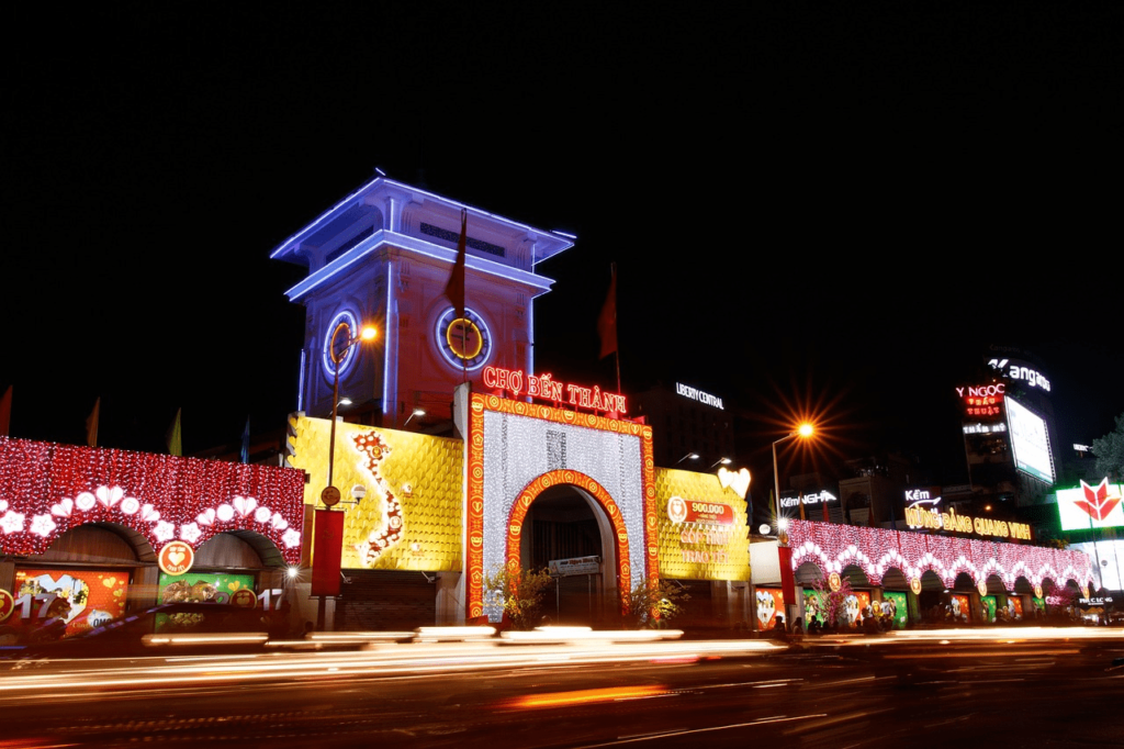 large clock tower lit up at night in vietnam city