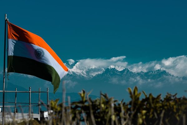 India flag waving with the Himalayas in the background, symbolizing India's growing role in global trade