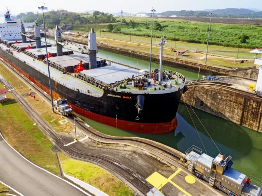 Cargo vessel transiting the Panama Canal, highlighting shipping logistics challenges and global sourcing risks during El Niño events.